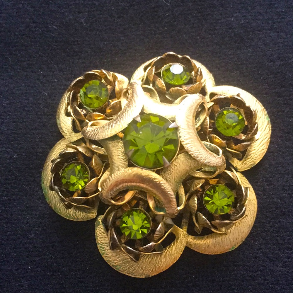 Vintage gold tone brooch with green stones